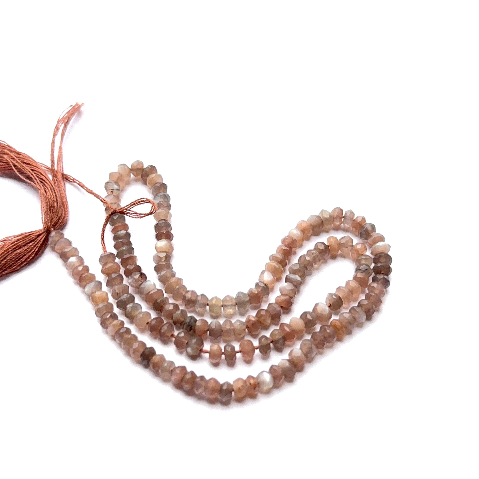 Close‑up of Chocolate Moonstone stone beads in faceted rondelle cut, highlighting soft glow for handmade jewellery components.