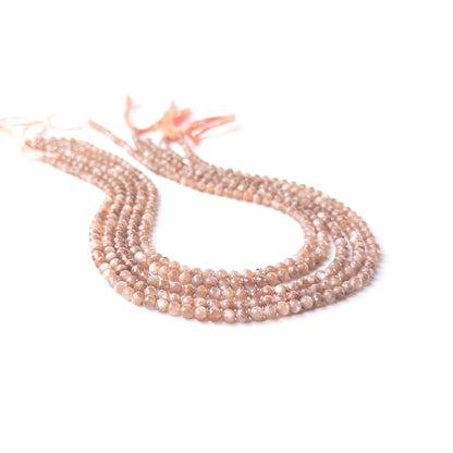 Handmade jewellery components featuring faceted Chocolate Moonstone rondelle beads in a neatly arranged strand.
