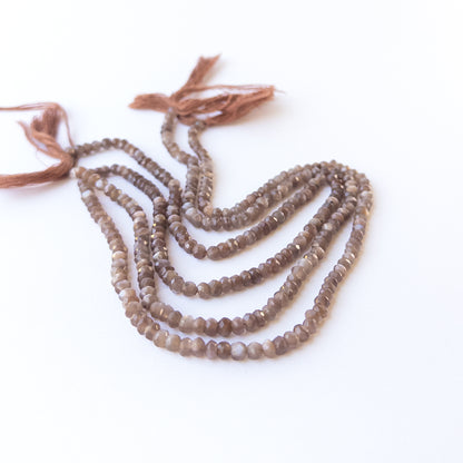 Genuine Chocolate Moonstone gemstone beads arranged on a 32cm strand, showcasing soft glow and fine clarity.
