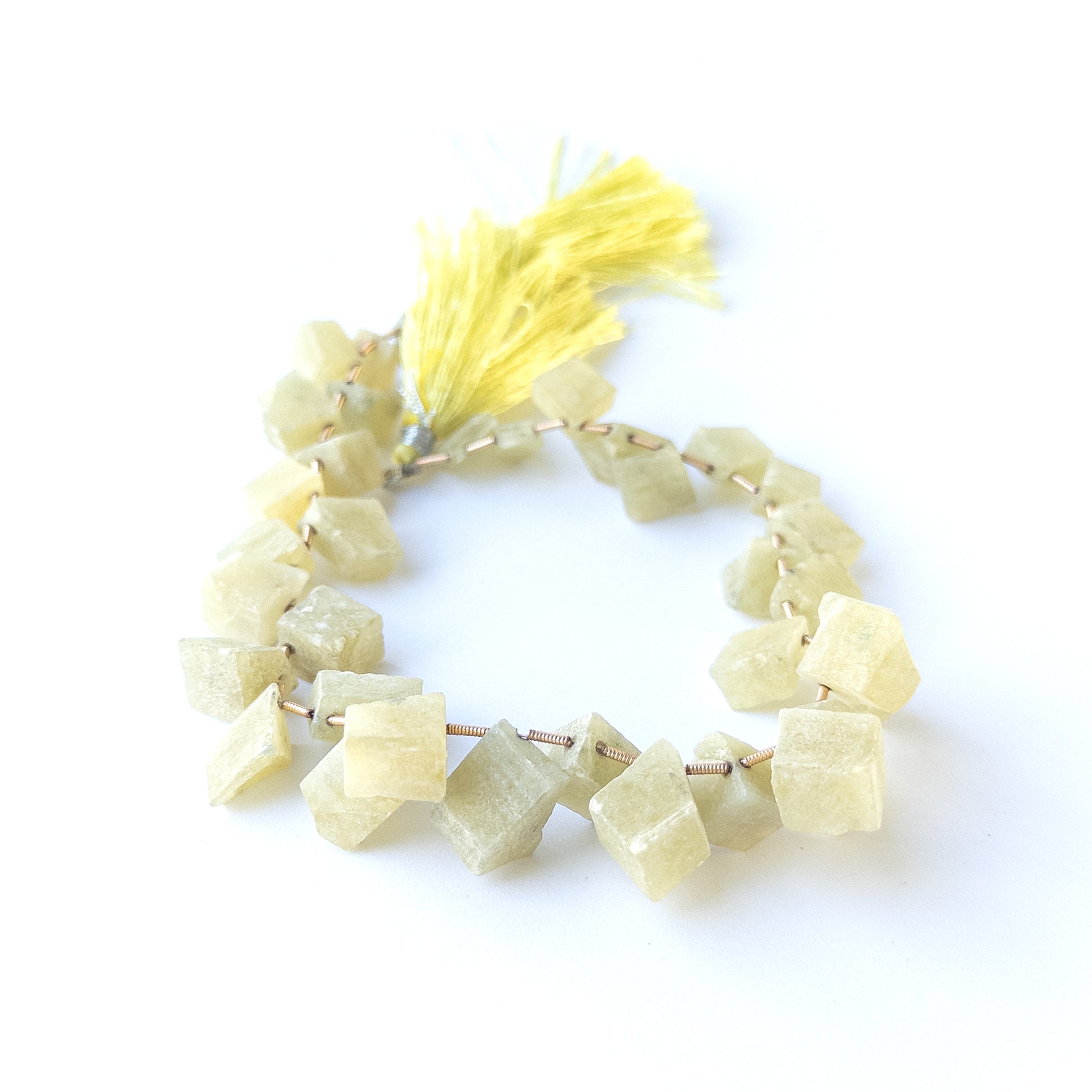Chrysoberyl Cat's Eye drilled rough gemstone beads showing natural chatoyancy and texture for handmade jewellery components.