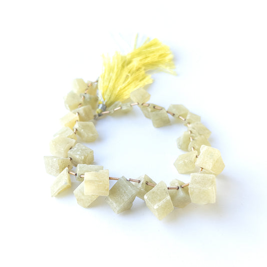 Chrysoberyl Cat's Eye drilled rough gemstone beads showing natural chatoyancy and texture for handmade jewellery components.