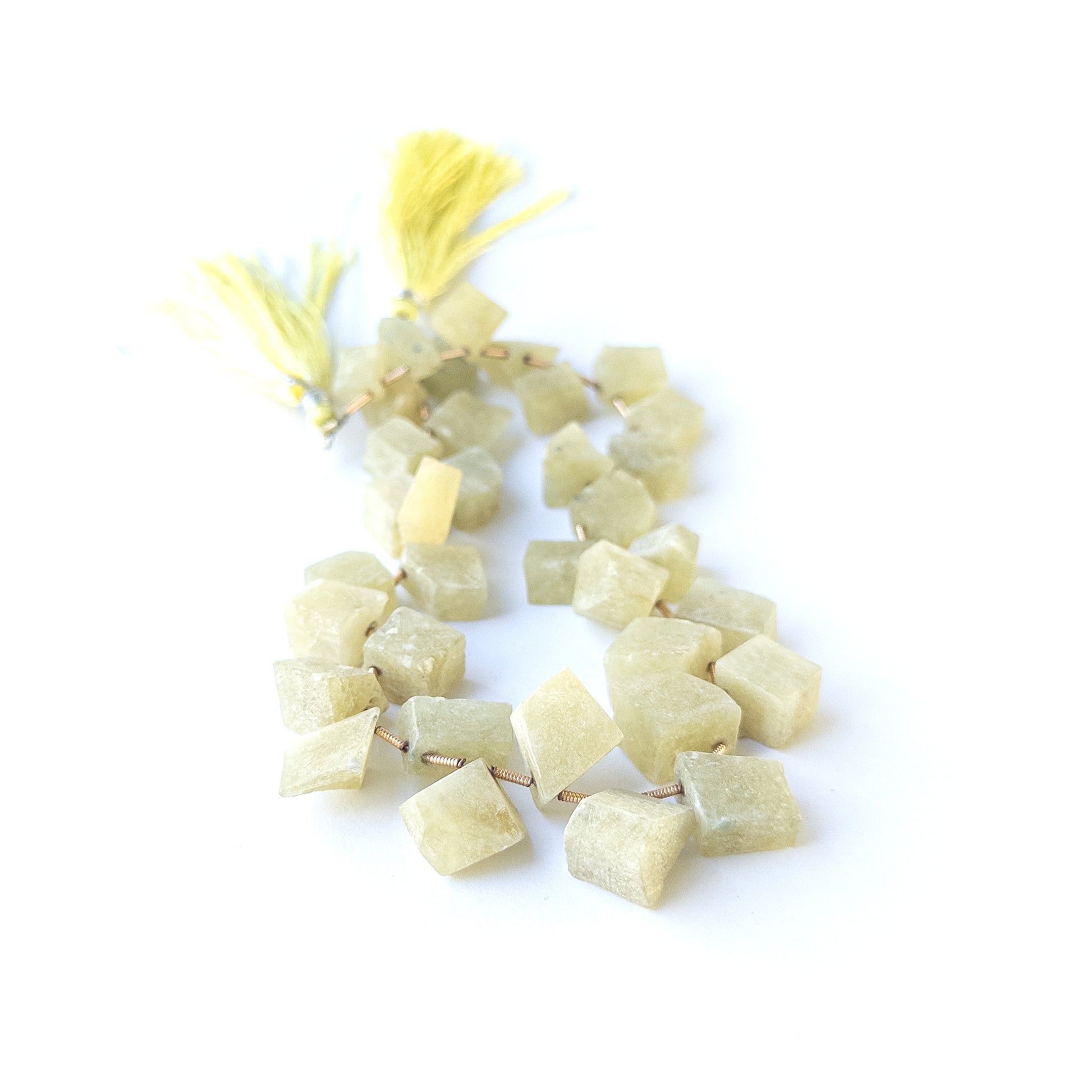 Authentic Cat's Eye Chrysoberyl rough beads showcasing natural shimmer, earthy tones and organic crystal shapes.