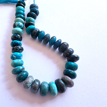 Strand of Chrysocolla gemstone rondelles arranged for DIY jewellery inspiration.