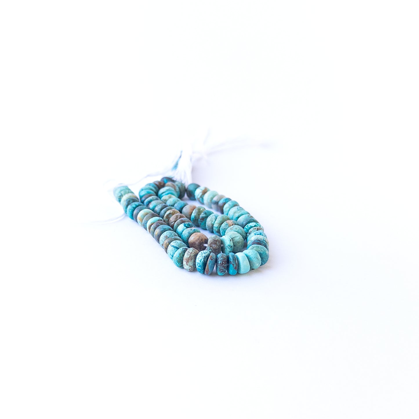 Chrysocolla smooth rondelles displaying natural colour variation and premium bead craftsmanship.