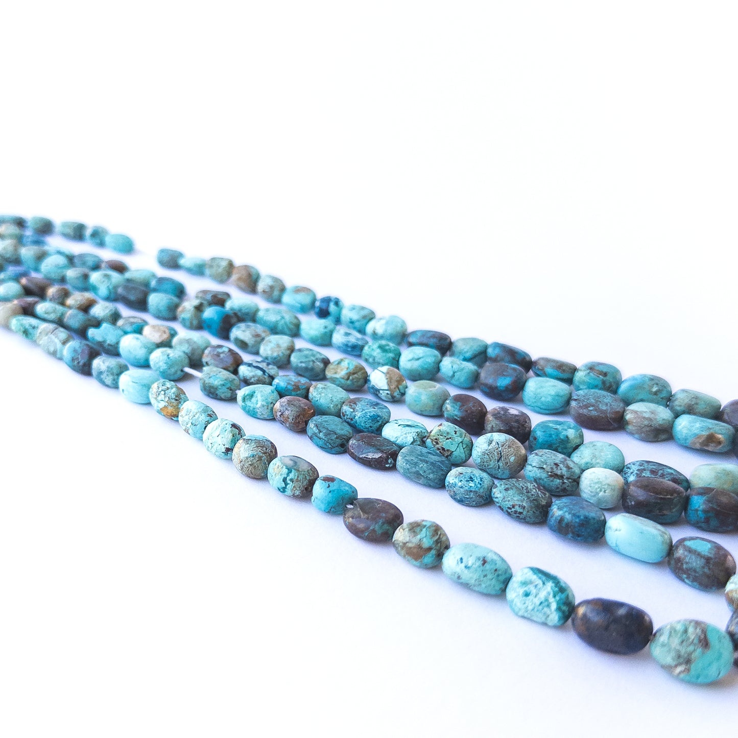 Handmade jewellery components featuring smooth Chrysocolla tumble gemstone beads.