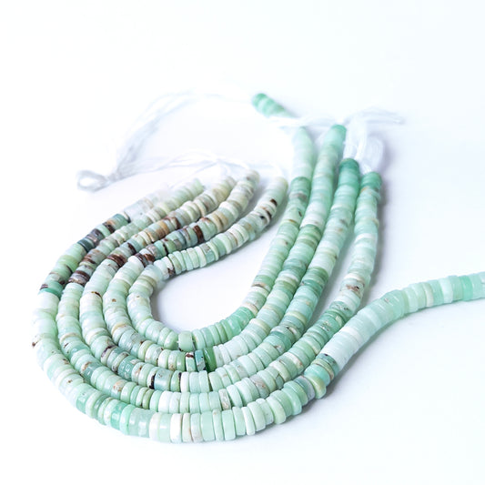 Close‑up of genuine Chrysoprase wheel heishi stone beads with clean shaping and vibrant green tone.