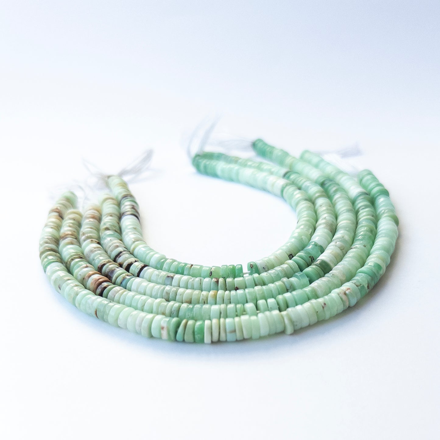 Close‑up of authentic Chrysoprase smooth wheel stone beads showing natural colour and shine for DIY jewellery making.