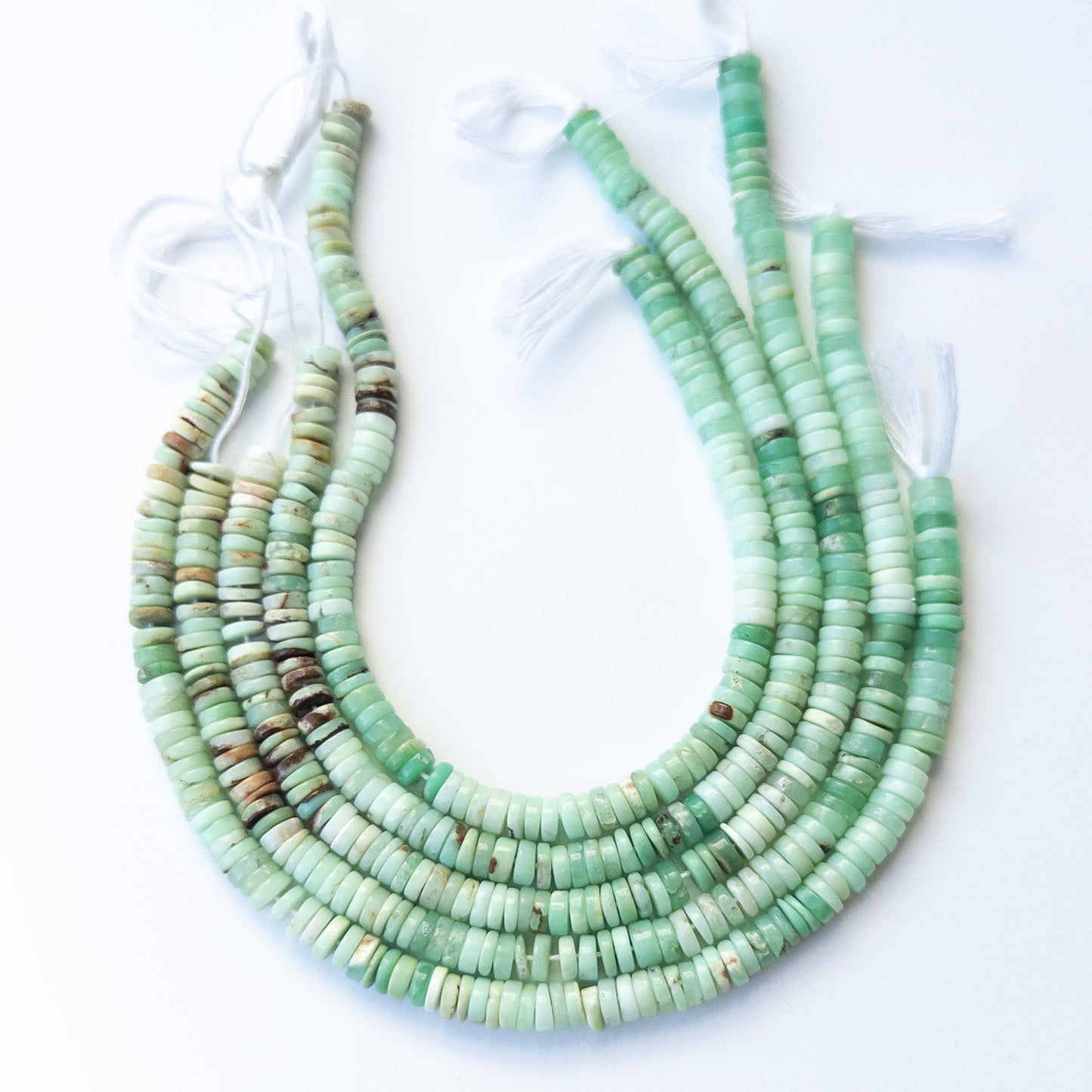 Genuine Chrysoprase gemstone beads in smooth wheel shape, displaying quality, colour, and polish for jewellery crafting.