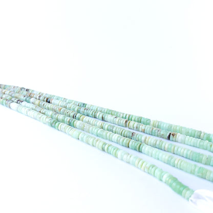 Close‑up of genuine Chrysoprase smooth wheel beads showing polished shine and natural pastel green tones.