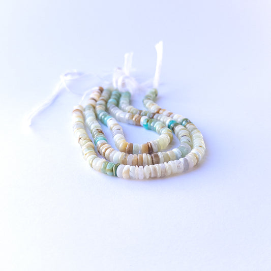 Authentic chrysoprase stone beads in polished smooth wheel cuts showing bright green colour for jewellery design work.