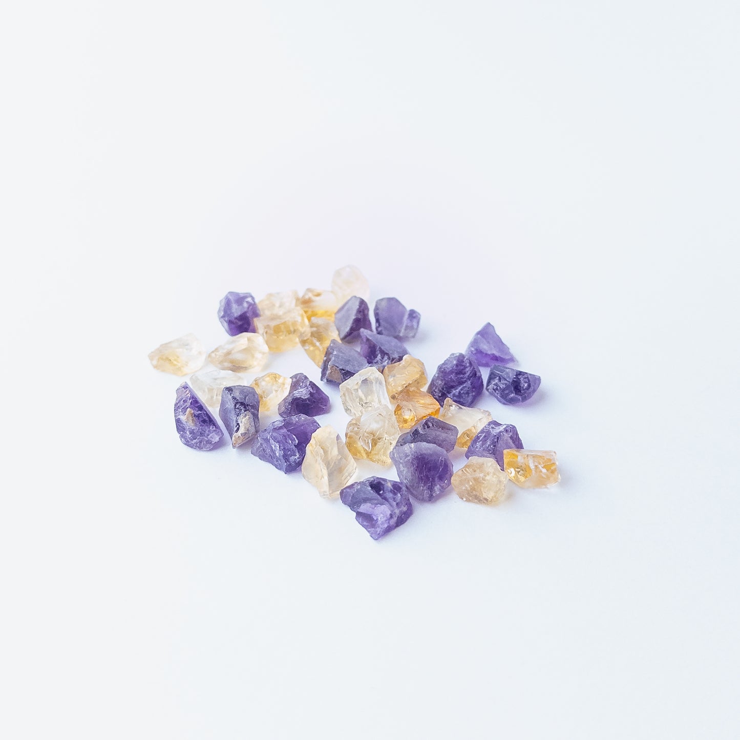 Premium rough Citrine and Amethyst gemstone pieces with organic shapes and natural crystalline surfaces.