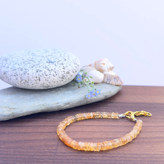 Citrine bracelet with 5.2mm smooth wheel-cut natural gemstone beads and adjustable lobster clasp.