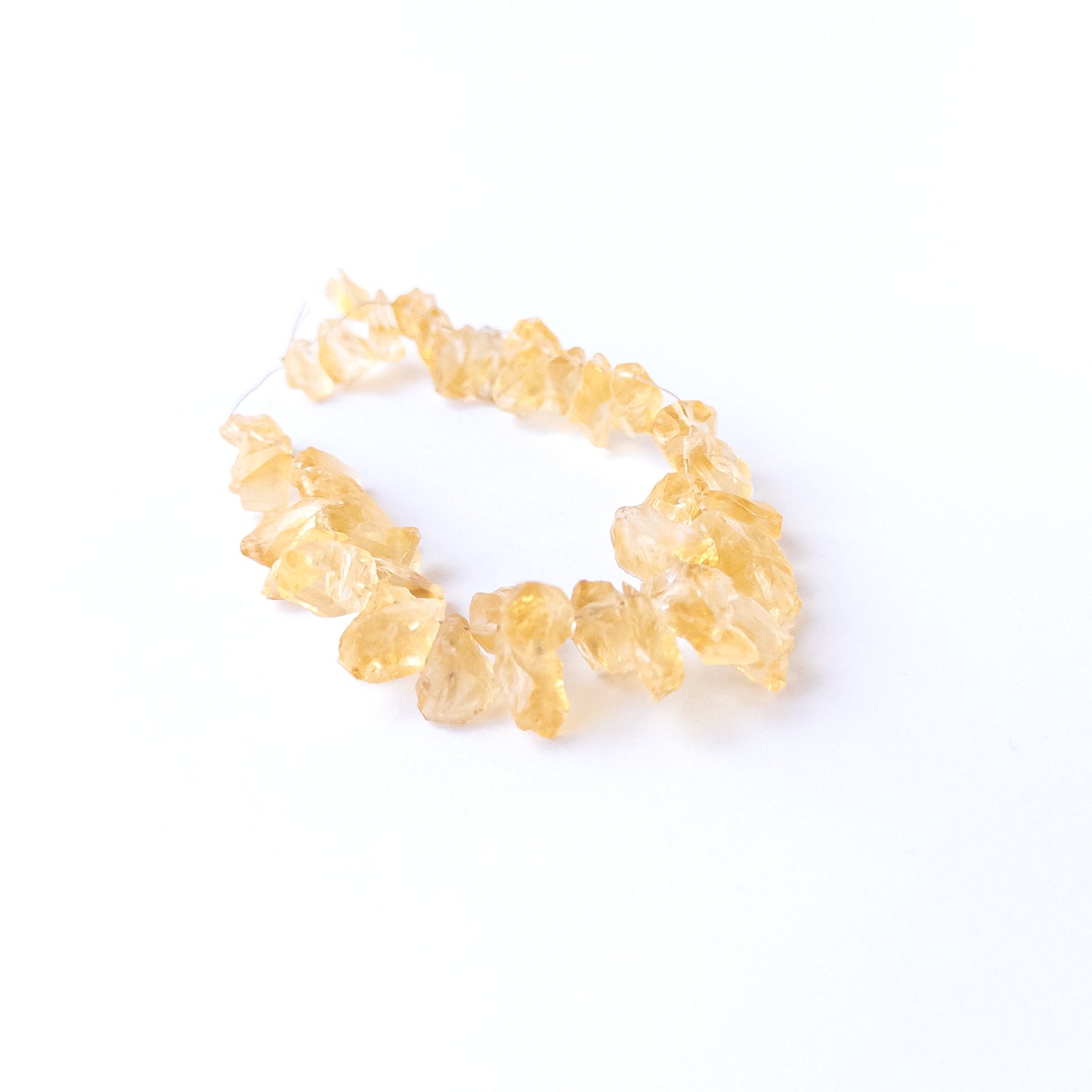 Authentic Citrine rough beads with natural texture arranged in a 40‑piece set for DIY jewellery creators.