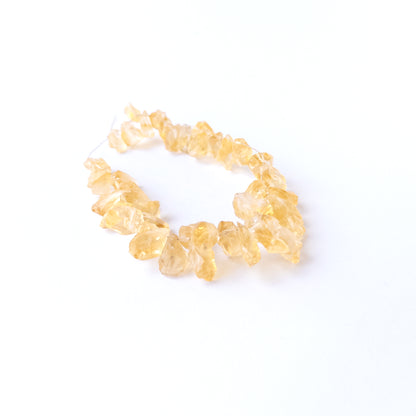 Authentic Citrine rough beads with natural texture arranged in a 40‑piece set for DIY jewellery creators.
