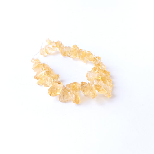 Authentic Citrine rough beads with natural texture arranged in a 40‑piece set for DIY jewellery creators.