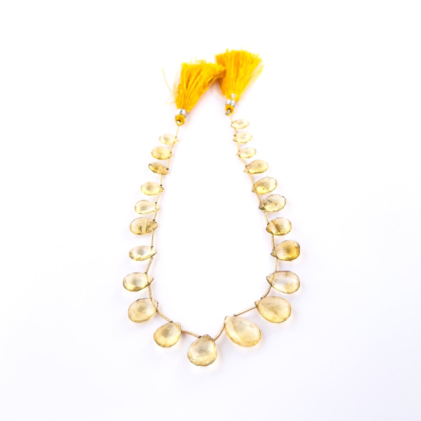 Close‑up of faceted Citrine briolettes with polished shine, perfect for authentic gemstone bead jewellery.