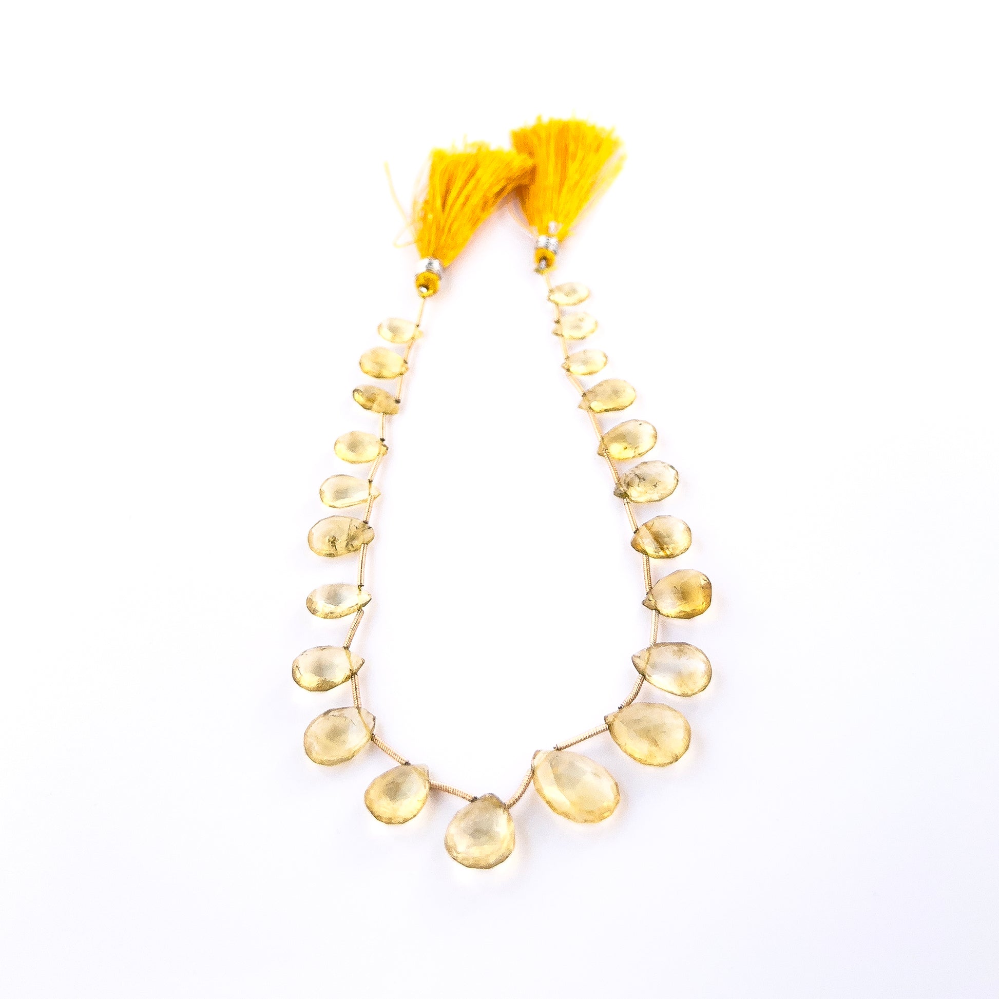 Close‑up of faceted Citrine briolettes with polished shine, perfect for authentic gemstone bead jewellery.
