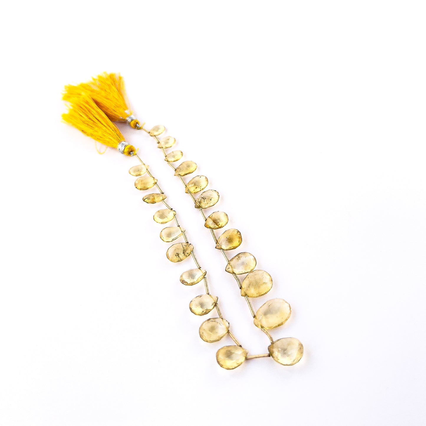 Citrine faceted briolette gemstone beads in warm golden tones arranged for handmade jewellery components.