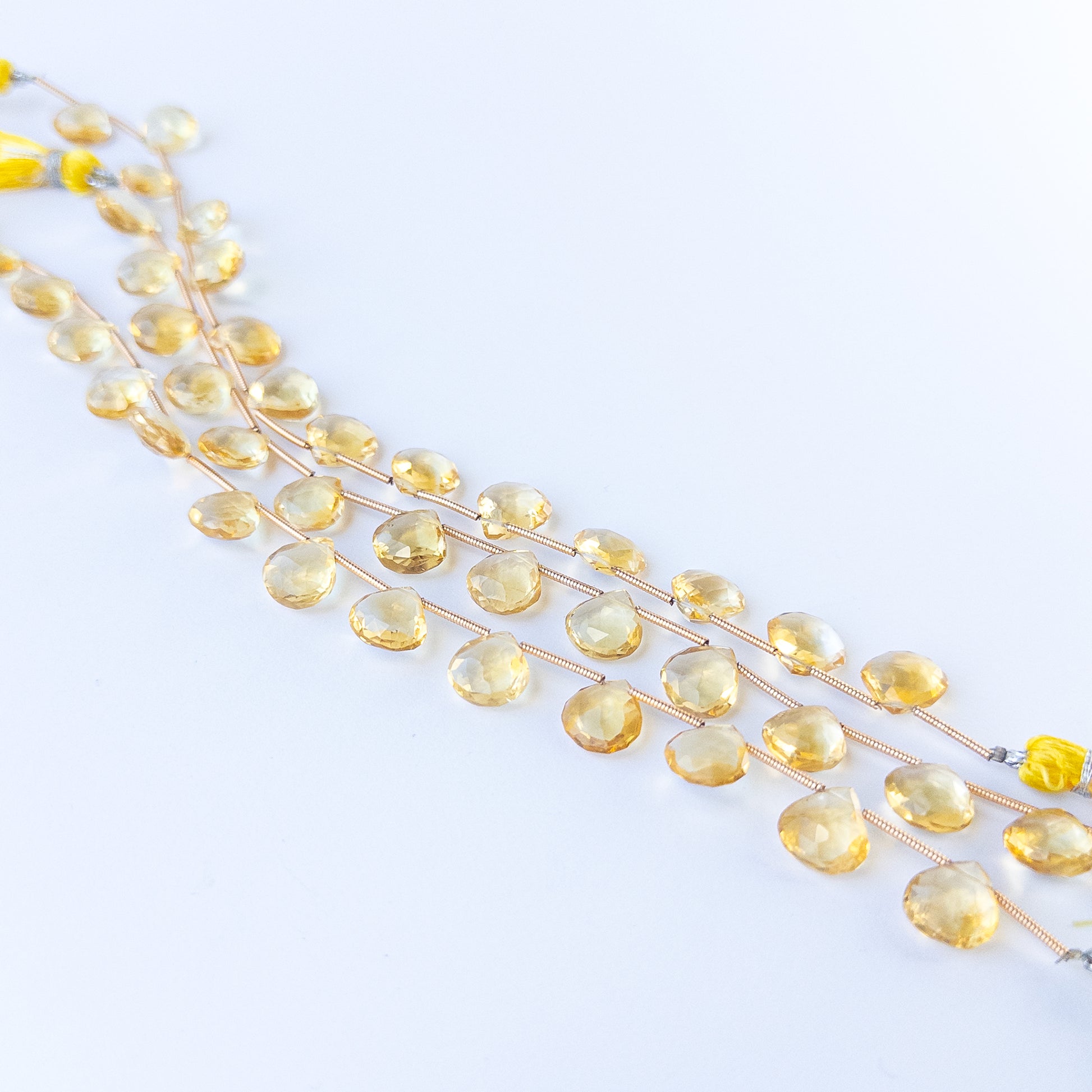 High‑quality Citrine faceted briolette beads in 9.5–10mm size offering brilliance and shine for artisan jewellery projects.
