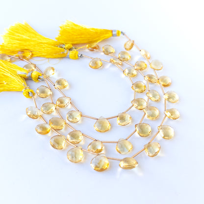 Citrine faceted briolette gemstone beads in warm golden tones arranged as 14 loose pieces for handmade jewellery components.