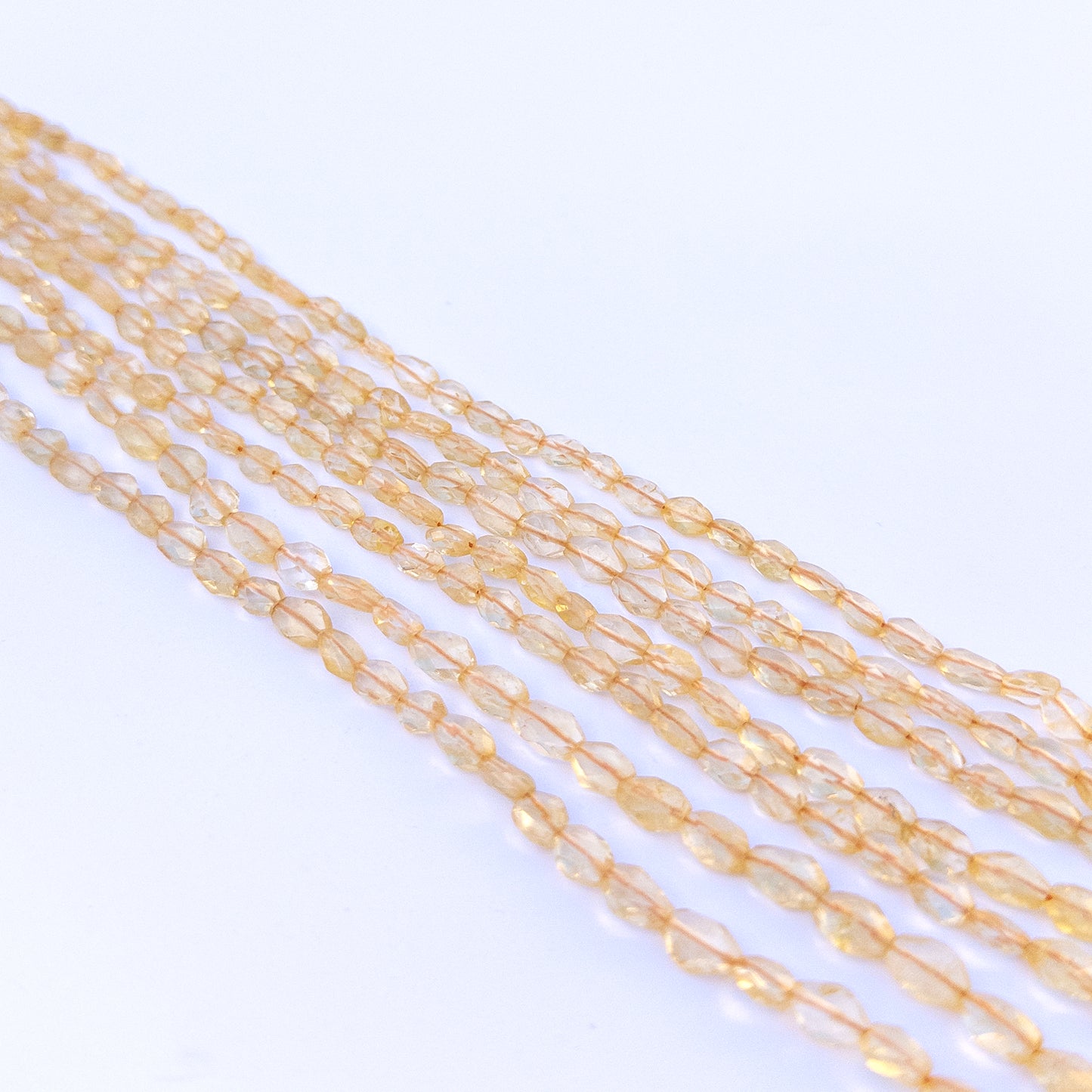 Strand of citrine faceted ovals displaying rich yellow colour and quality cut for gemstone beads for DIY jewellery.