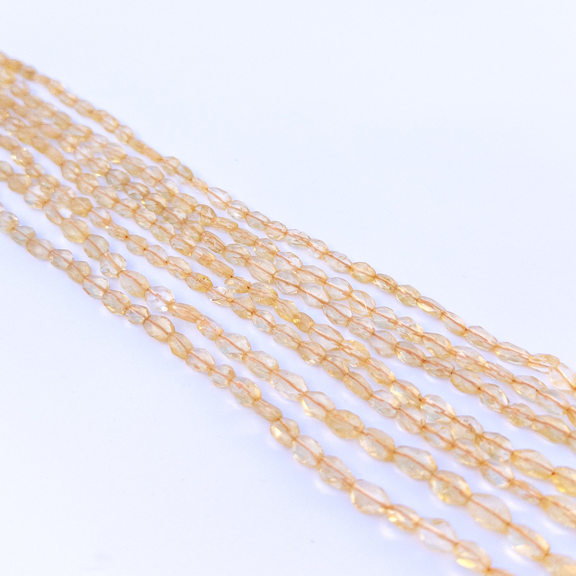 Strand of citrine faceted ovals displaying rich yellow colour and quality cut for gemstone beads for DIY jewellery.