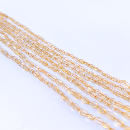 Strand of citrine faceted ovals displaying rich yellow colour and quality cut for gemstone beads for DIY jewellery.