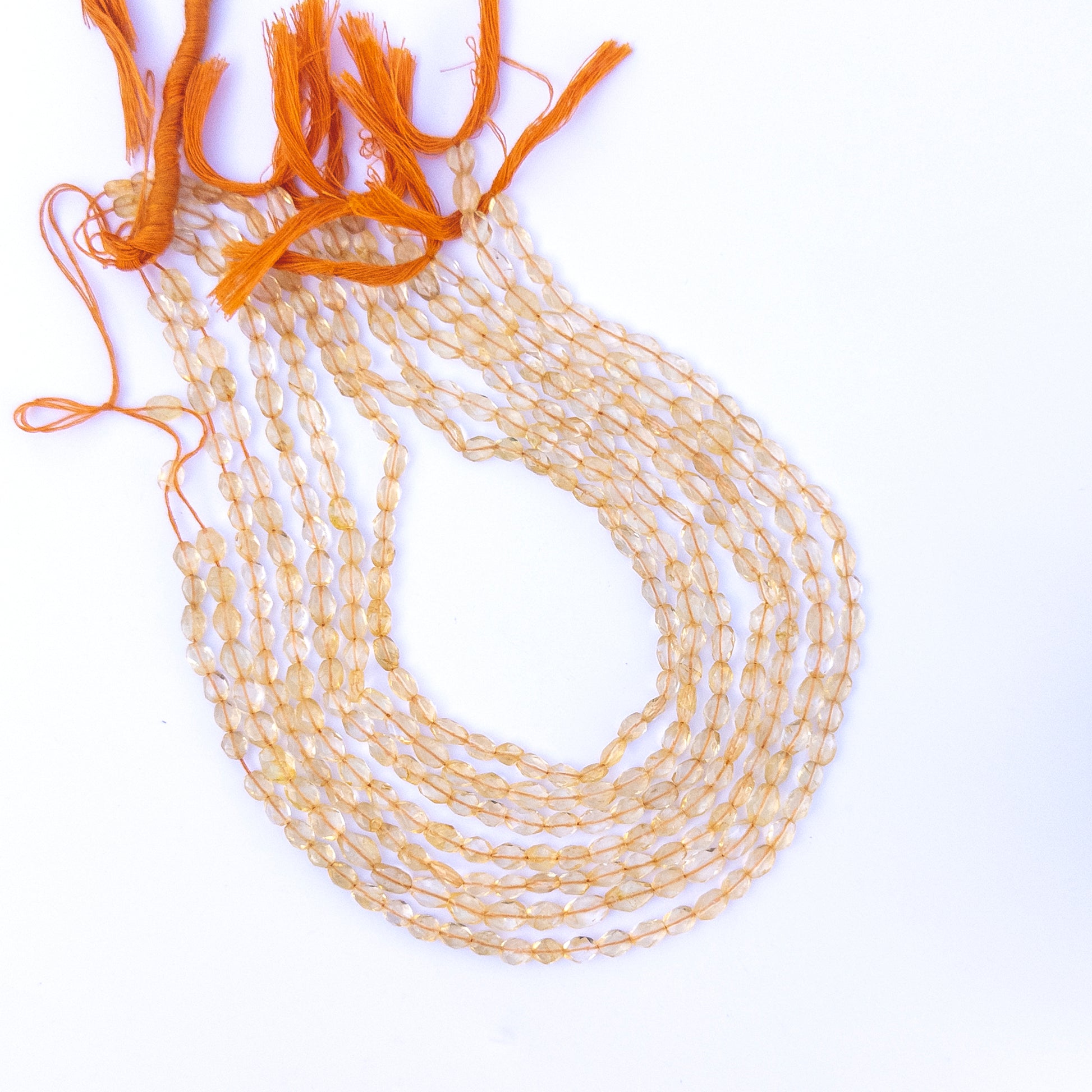 Detailed view of citrine oval beads with crisp faceting and natural golden glow for handmade jewellery components.