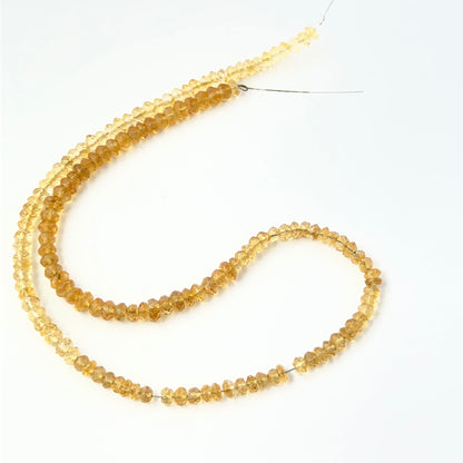Citrine faceted rondelle beads with bright reflective surfaces, perfect for authentic gemstone beads and creative jewellery designs.