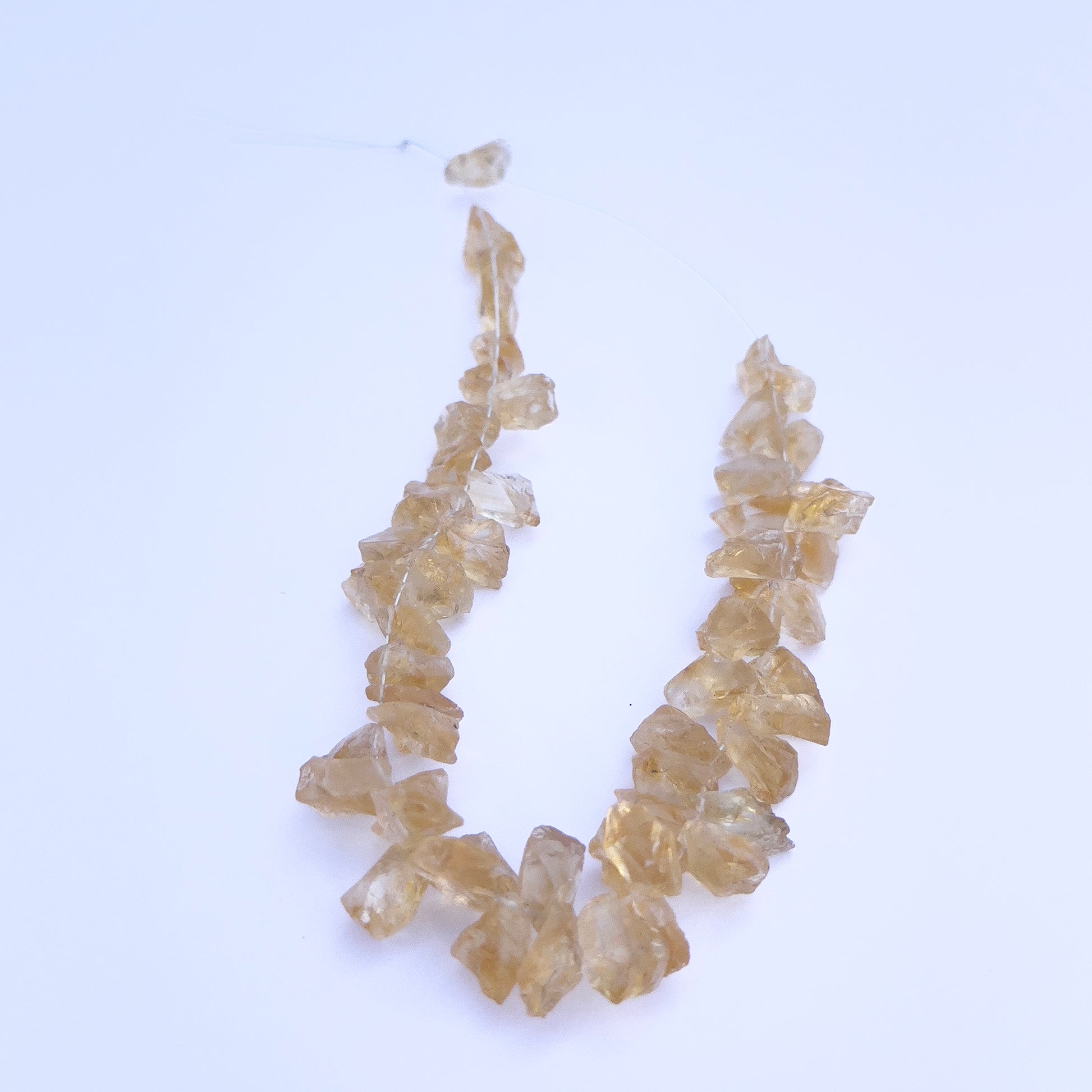 Natural gemstone beads for DIY jewellery showcasing drilled Citrine in rough cut. 