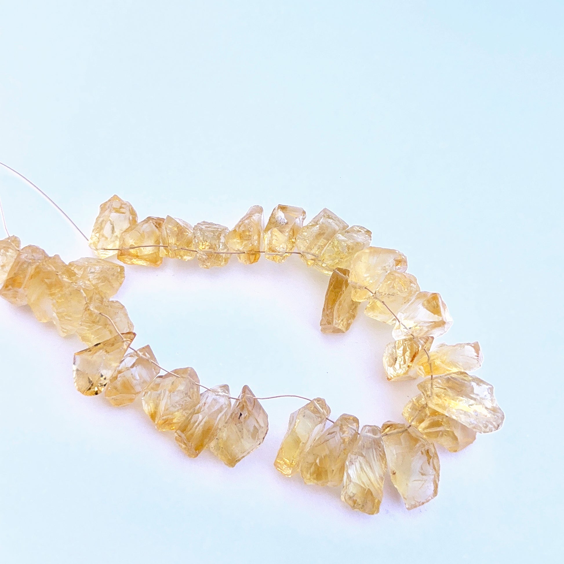 Stone beads showcasing raw citrine texture and natural colour variation. 