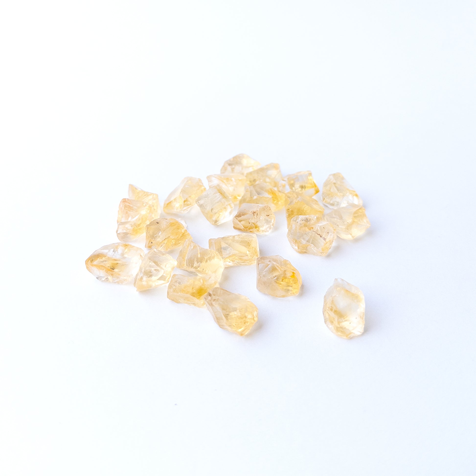 Premium Citrine rough gemstone pieces arranged together with natural sparkle and organic shapes.