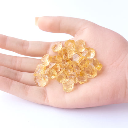 A person holds delicate pieces of Citrine rough, showcasing their natural design.