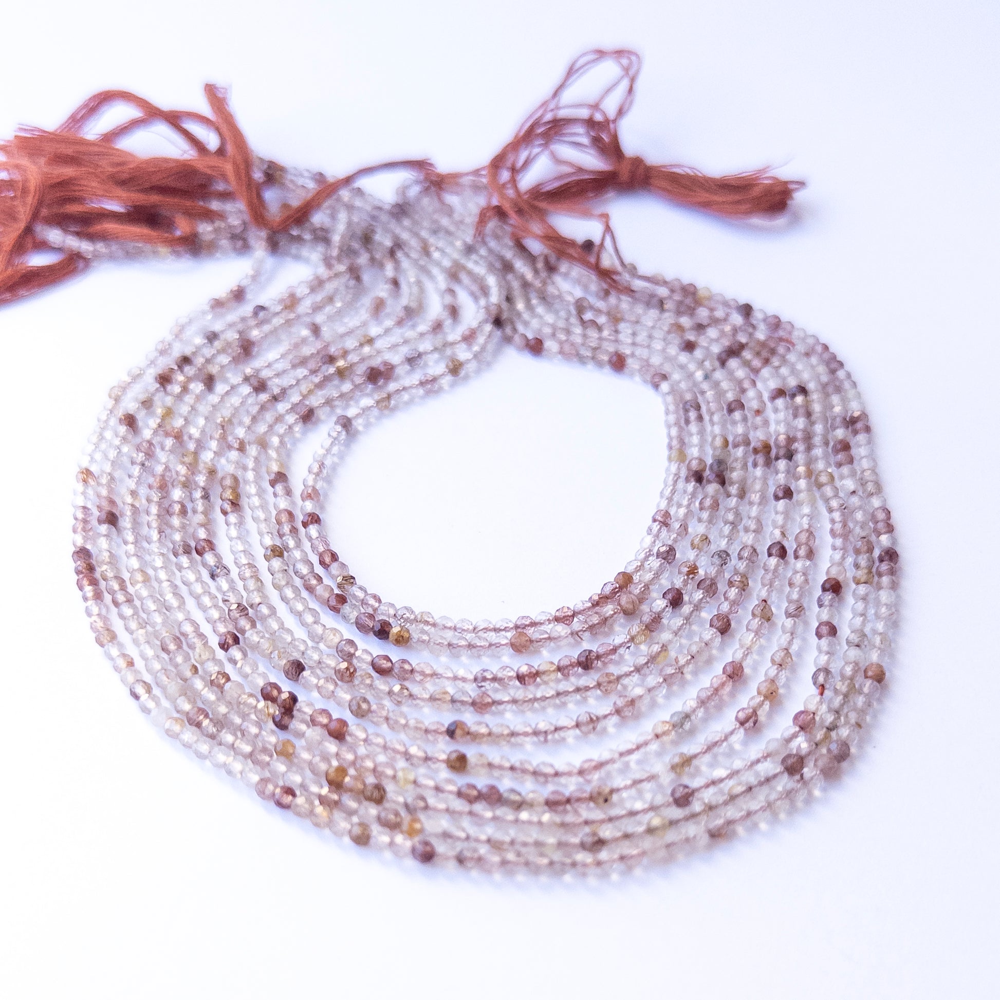 Close‑up of authentic Copper Rutile faceted rondelle stone beads highlighting sparkle, clarity, and natural inclusions for DIY jewellery making.