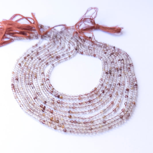 Close‑up of authentic Copper Rutile faceted rondelle stone beads highlighting sparkle, clarity, and natural inclusions for DIY jewellery making.