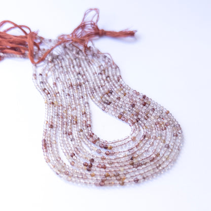 Premium Copper Rutile gemstone beads in faceted rondelle cut arranged in strands, showcasing warm tones for jewellery designers.
