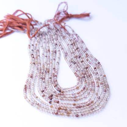 Copper Rutile faceted rondelle beads with natural variation, perfect for handmade jewellery components and creative beadwork.