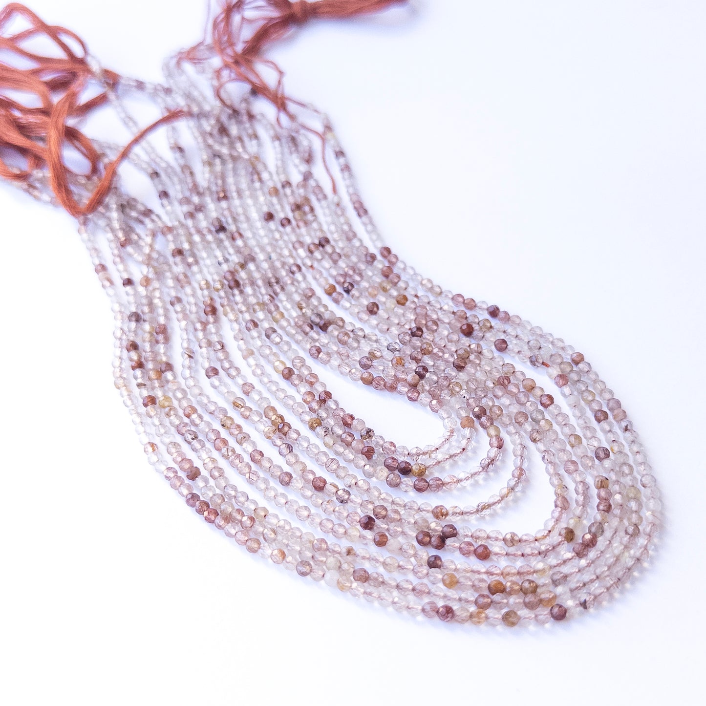 Genuine Copper Rutile gemstone beads in faceted rondelle shape, displaying polish, shimmer, and natural beauty for jewellery crafting.