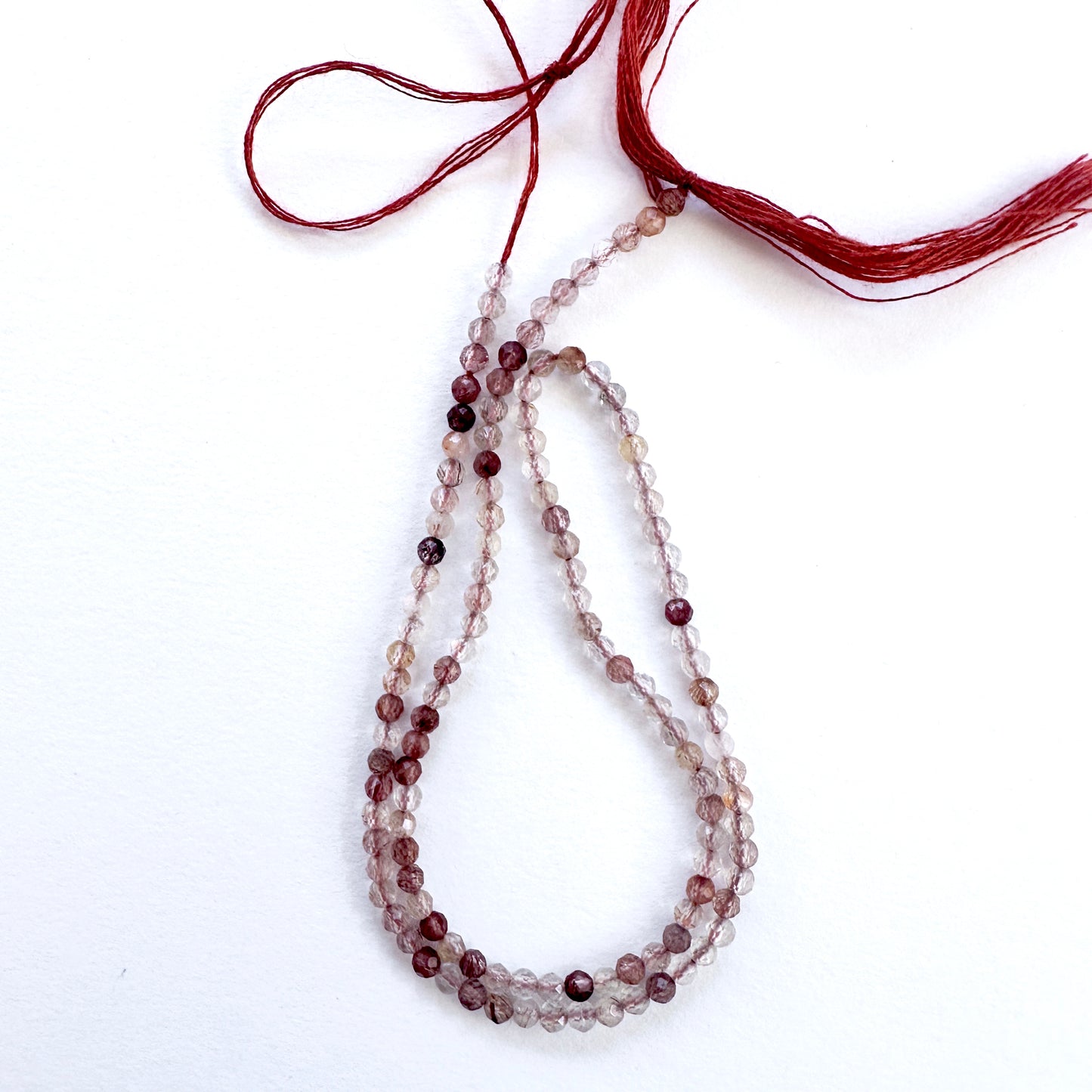Close-up of Copper Rutile micro faceted rondelle beads with golden-copper inclusions and sparkle.