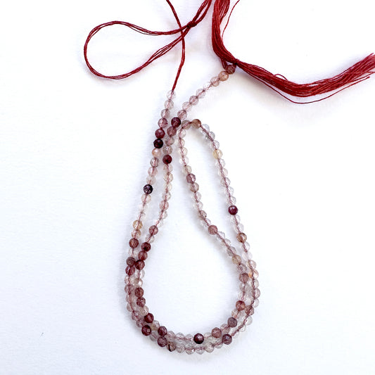 Close-up of Copper Rutile micro faceted rondelle beads with golden-copper inclusions and sparkle.