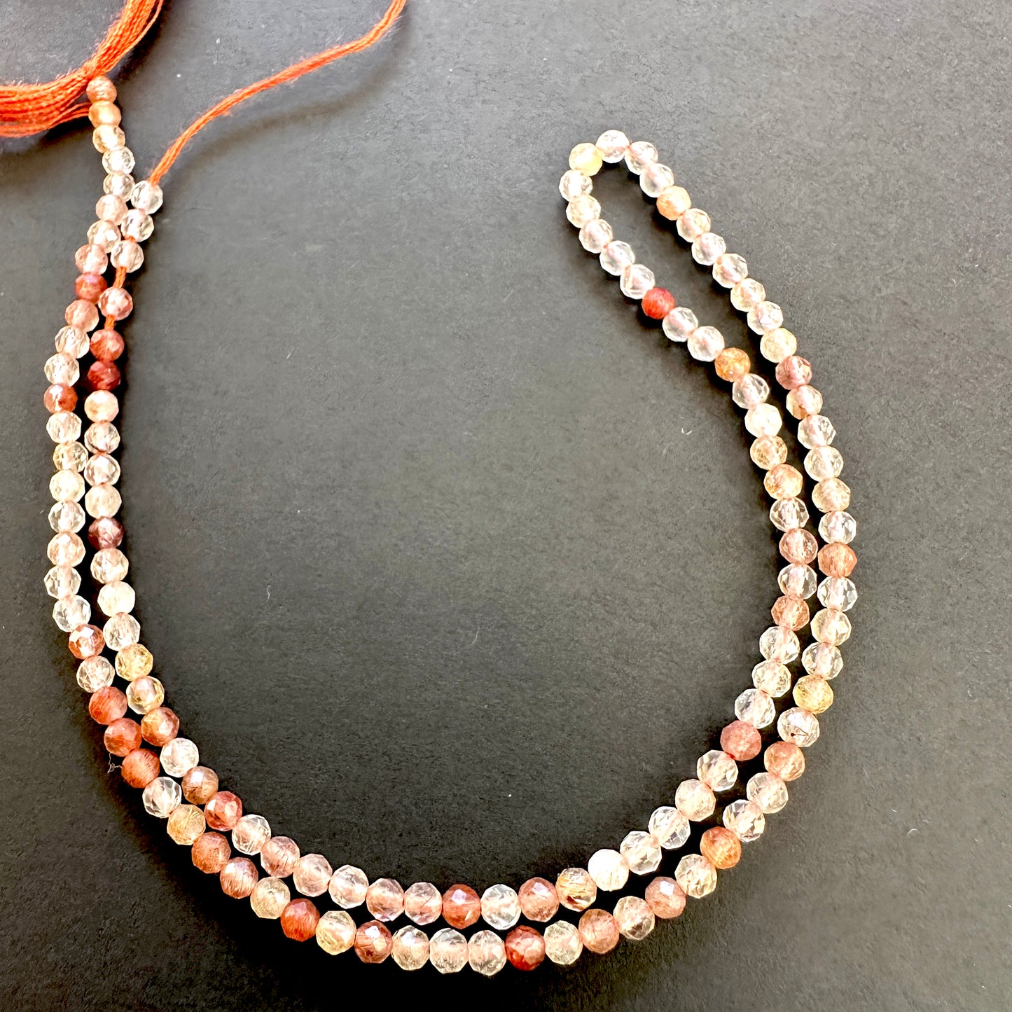 High-quality Copper Rutile natural gemstone beads with warm tones and clarity.