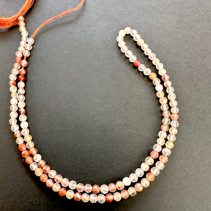 High-quality Copper Rutile natural gemstone beads with warm tones and clarity.