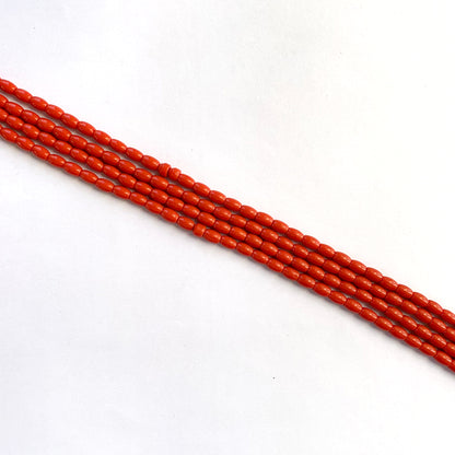 Smooth coral gemstones with natural drum shape ranging from 6.4x4.1mm to 6.7x4.4mm.