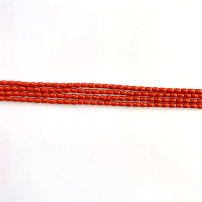 Natural coral texture and hue displayed in a strand of even-sized drum cut beads.