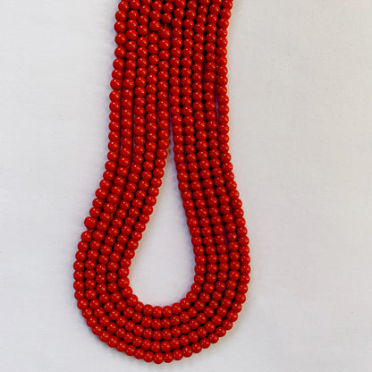 Vivid coral round beads in 4.3-4.5mm sizes, neatly arranged along a 35cm strand.