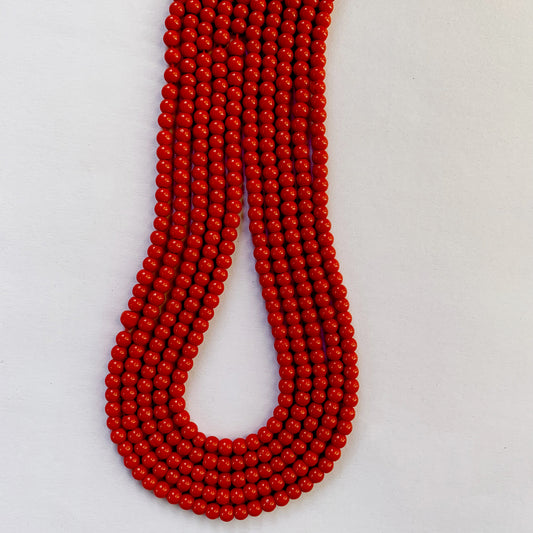 Vivid coral round beads in 4.3-4.5mm sizes, neatly arranged along a 35cm strand.