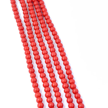 Smooth round Taiwan Coral stone beads showing vibrant colour and handmade jewellery component quality.