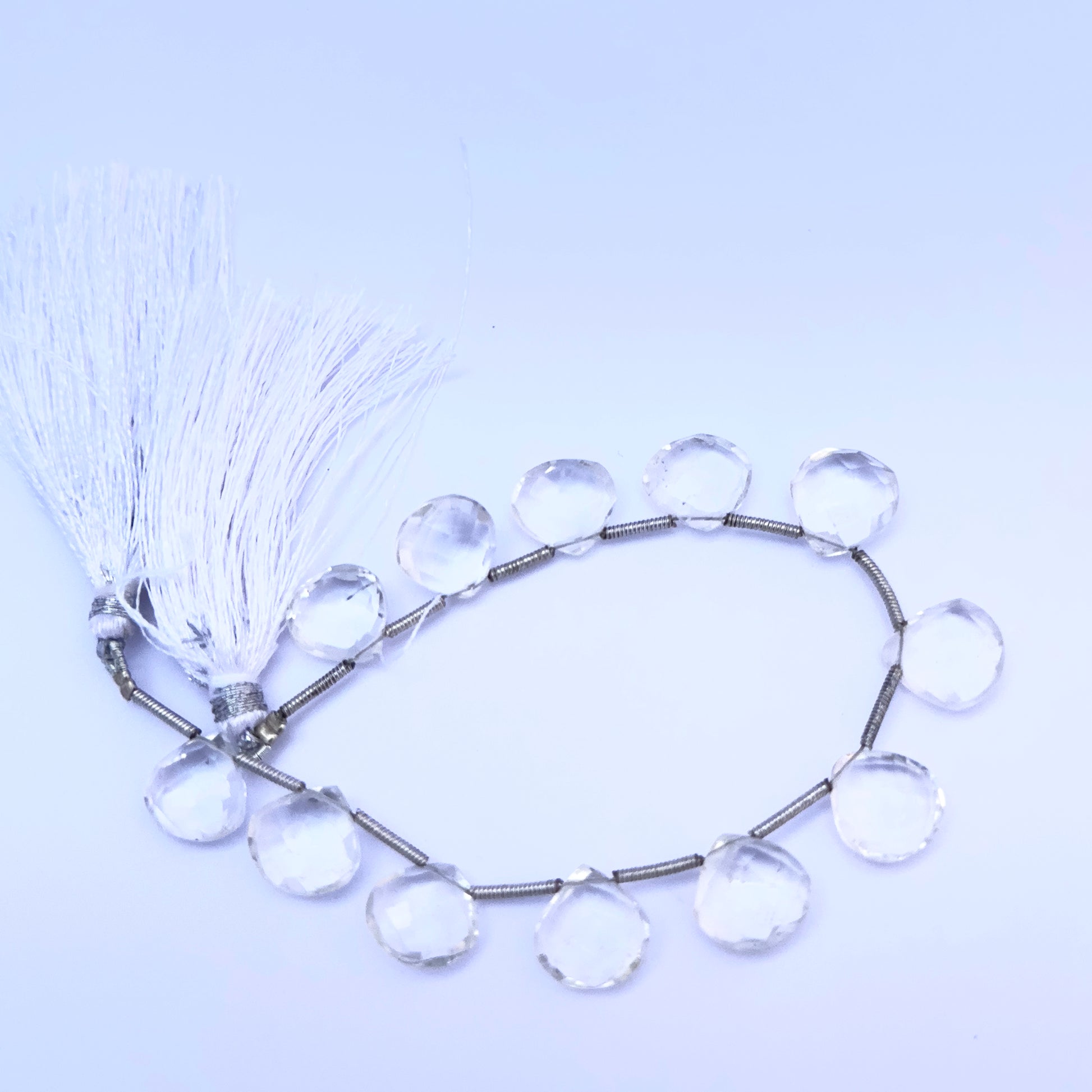 Close-up of Crystal heart briolette beads showing their clarity, cut, and reflective sparkle.