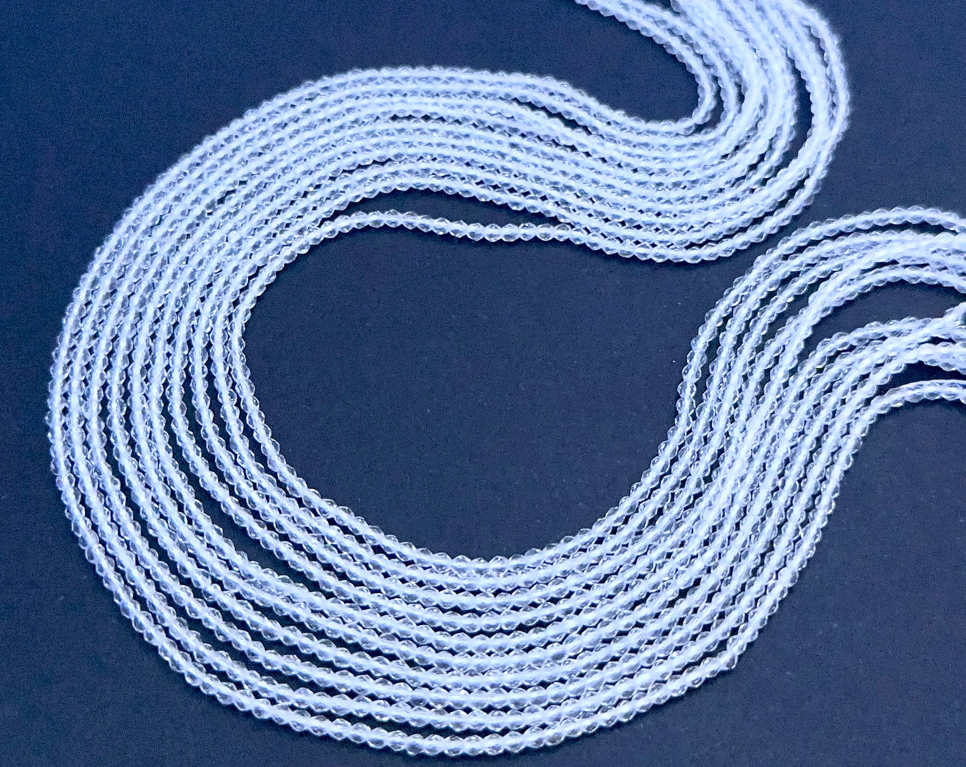 Close-up of Crystal rondelle beads showing their fine cut and polished clarity.