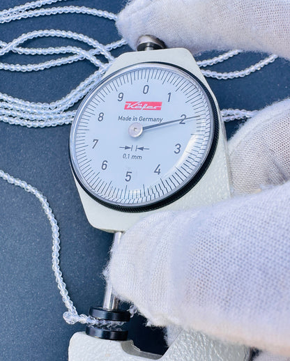 A dial gauge measures the Crystal faceted rondelle 2.2mm gemstone.